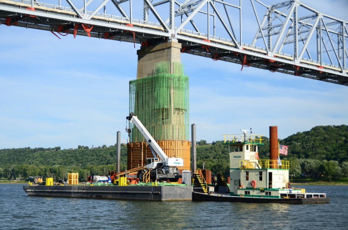 barge in water under bridge
